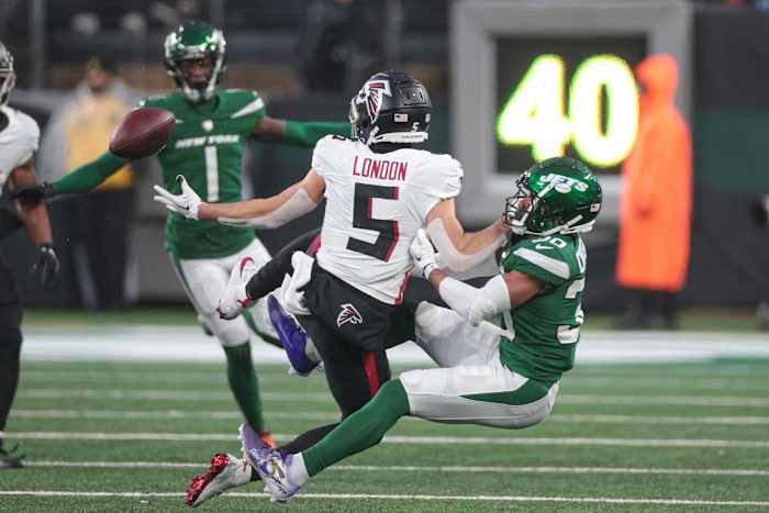 Dec 3, 2023; East Rutherford, New Jersey, USA; New York Jets cornerback Michael Carter II (30) breaks up a pass intended of Atlanta Falcons wide receiver Drake London (5) during the second half at MetLife Stadium. Mandatory Credit: Vincent Carchietta-USA TODAY Sports